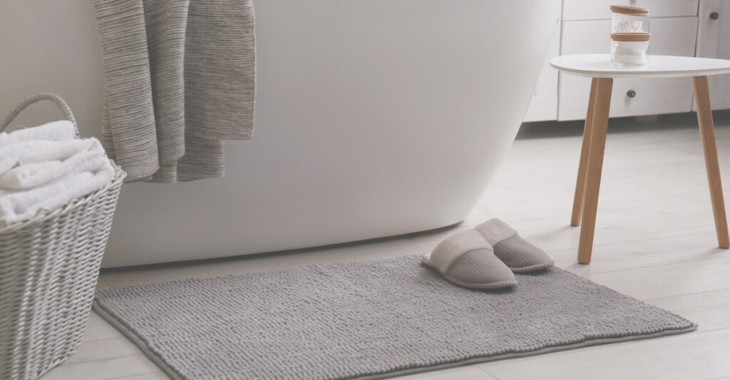 bath rug outside of a tub